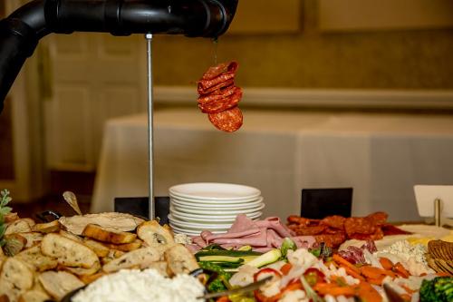 photo of a cheese and cracker spread with bread, crackers, various dips, and salamis