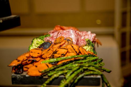 Close up photograph of grilled vegetables including asparagus and carrots