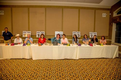 A row of people sitting behind a table
